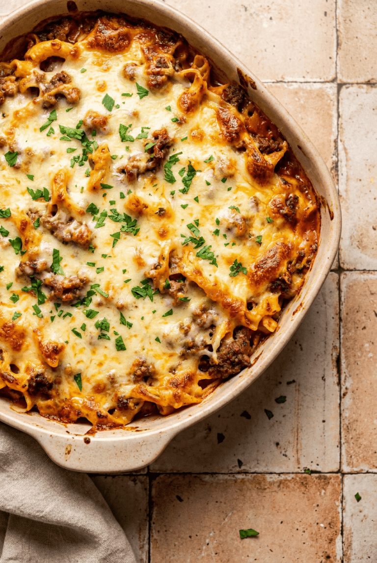 cheesy ground beef and pasta casserole recipe - Cheesy Ground Beef and Pasta Casserole served in a white bowl overhead view
